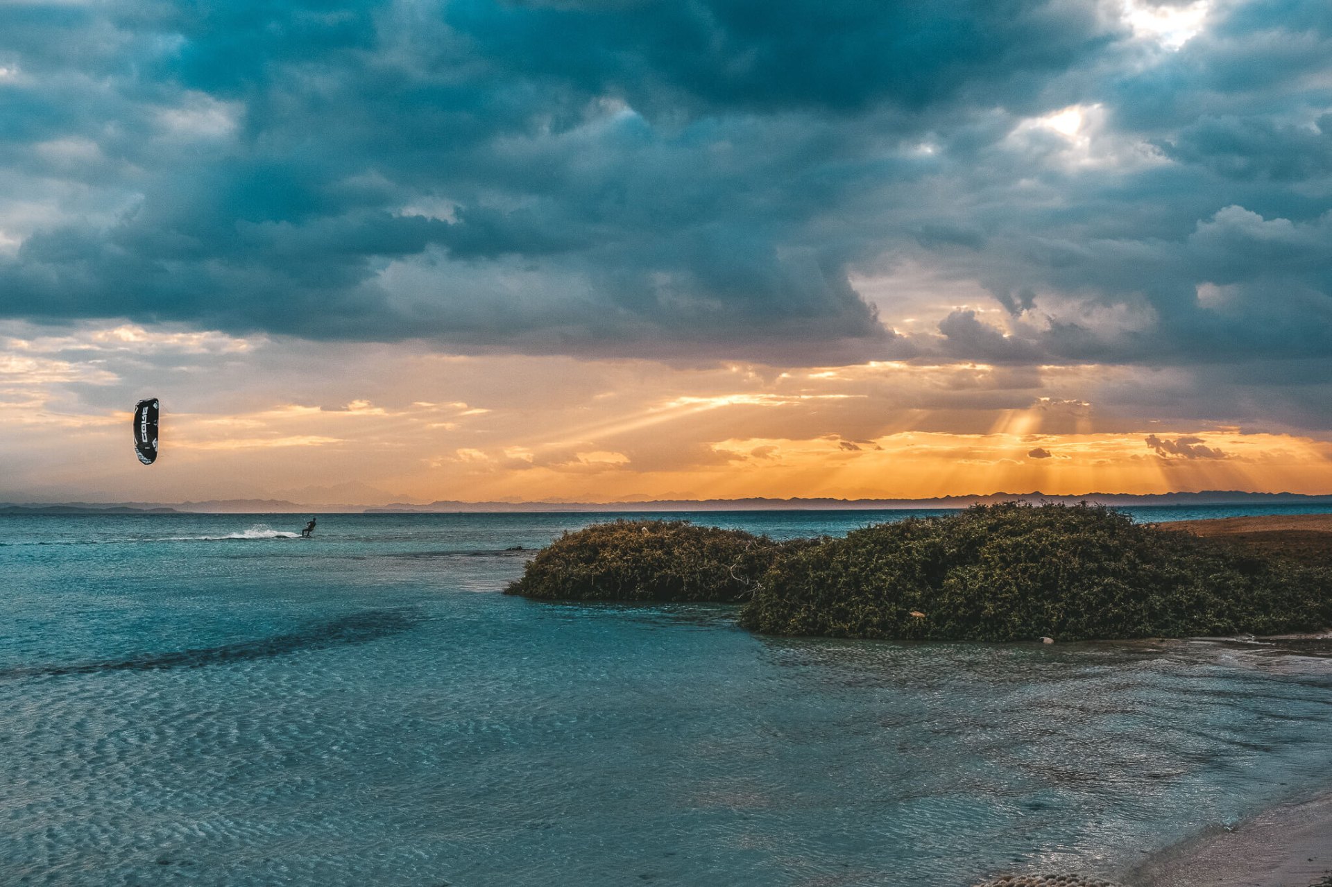 Professional kitesurfer riding waves